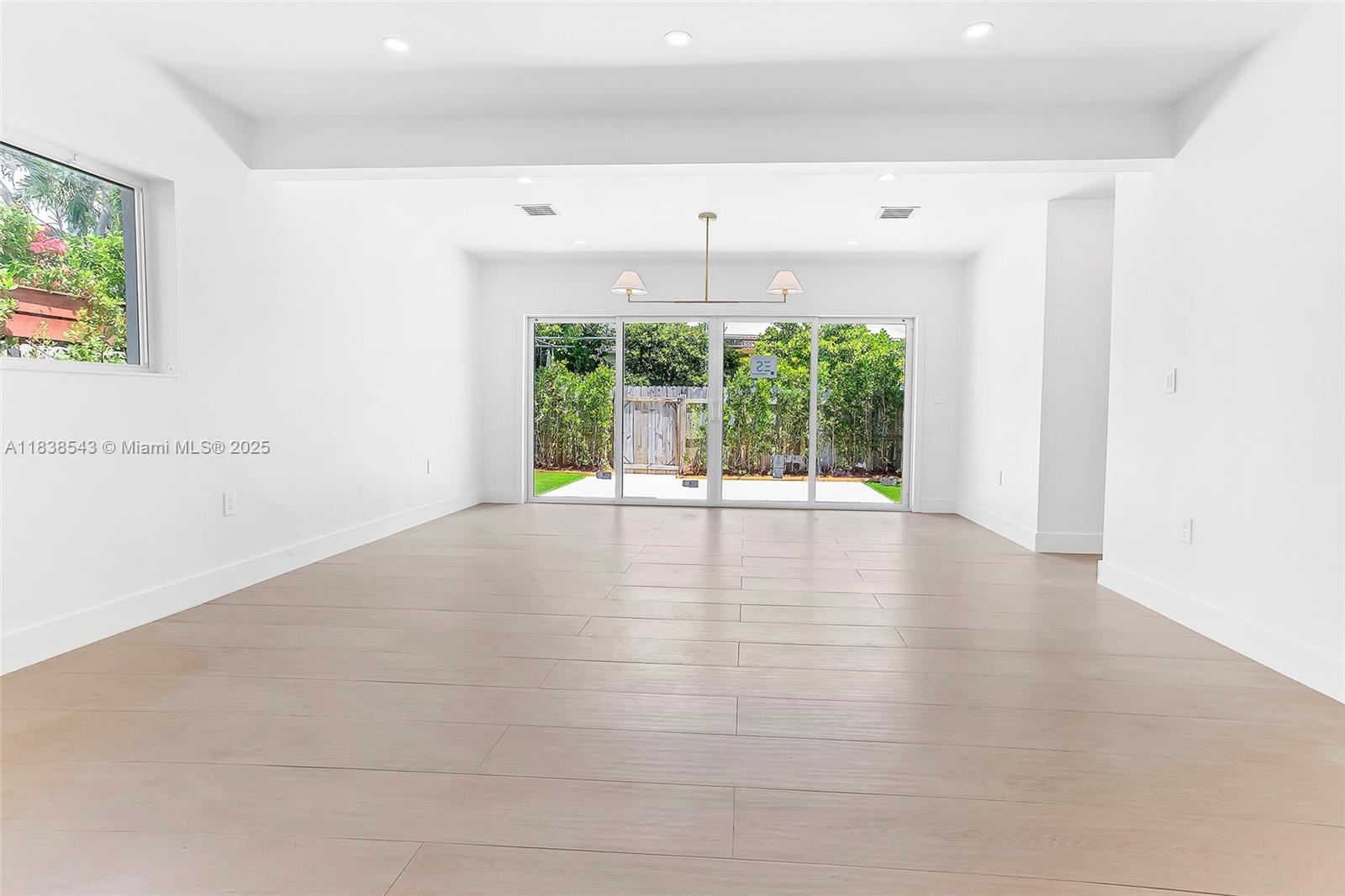 Normandy Isle Miami Beach, FL 33141 - Photo 24 of 43 a view of an empty room with wooden floor and a window