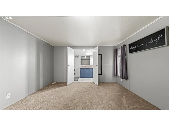 a room with a bed and cabinets