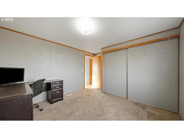 a bathroom with a sink a toilet a mirror and shower