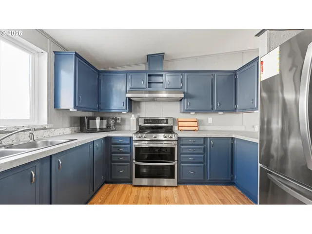 a kitchen with a sink stainless steel appliances and cabinets