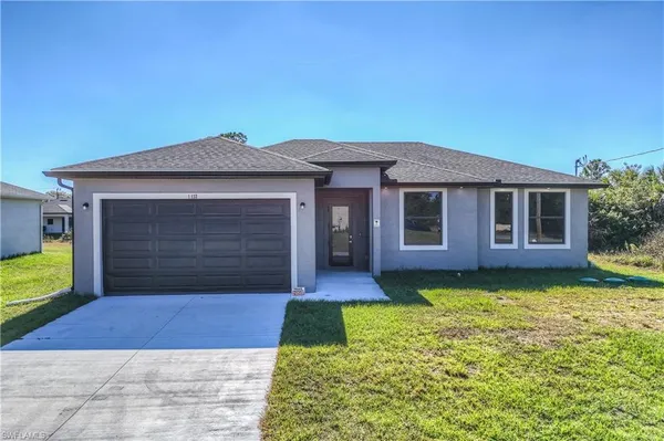 a front view of a house with a yard