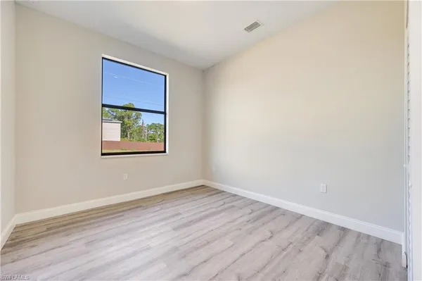 an empty room with wooden floor