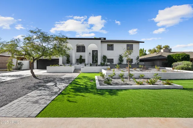 a front view of a house with a garden and patio
