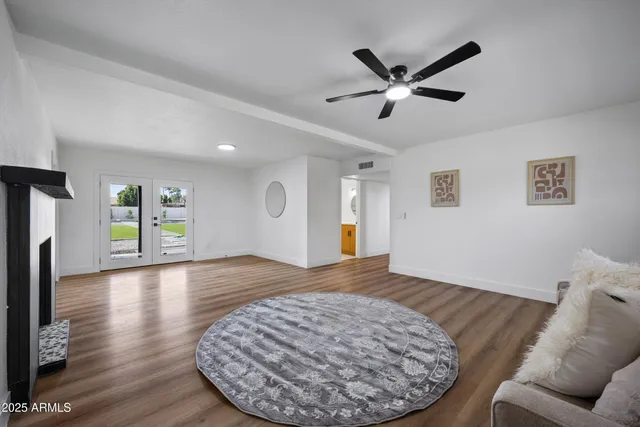 a view of livingroom with hardwood floor and ceiling fan
