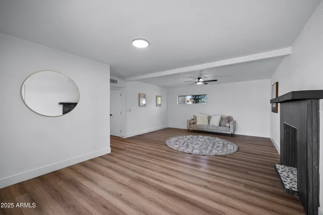 a view of a livingroom with wooden floor and a front door