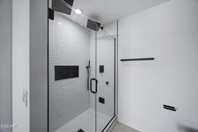 a bathroom with a shower and a glass door
