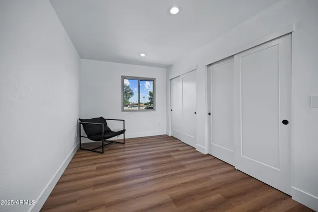 a view of room with wooden floor lounge chair and windows