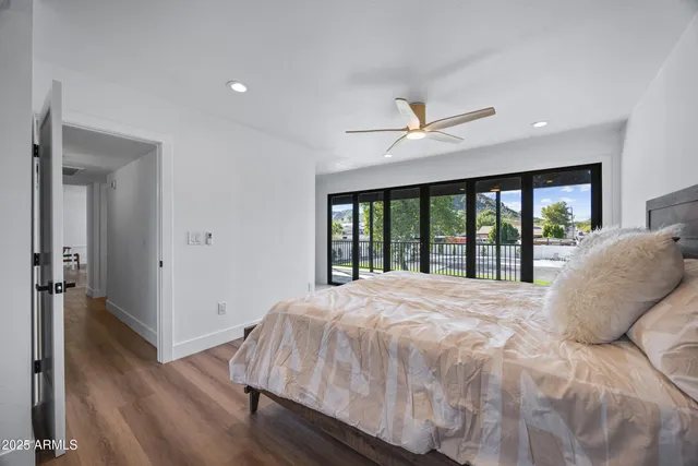a bedroom with a large bed and a large window