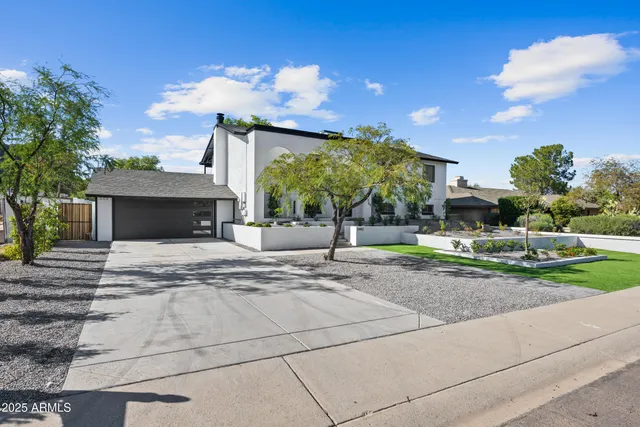 a view of a house with a yard and a garden