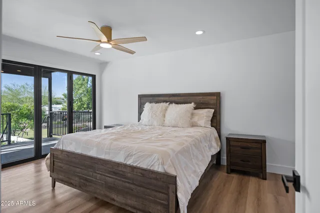 a bedroom with a bed and a large window