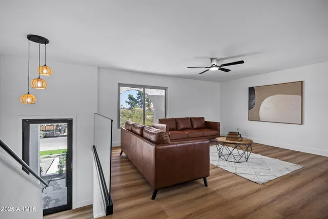 a living room with furniture and a wooden floor