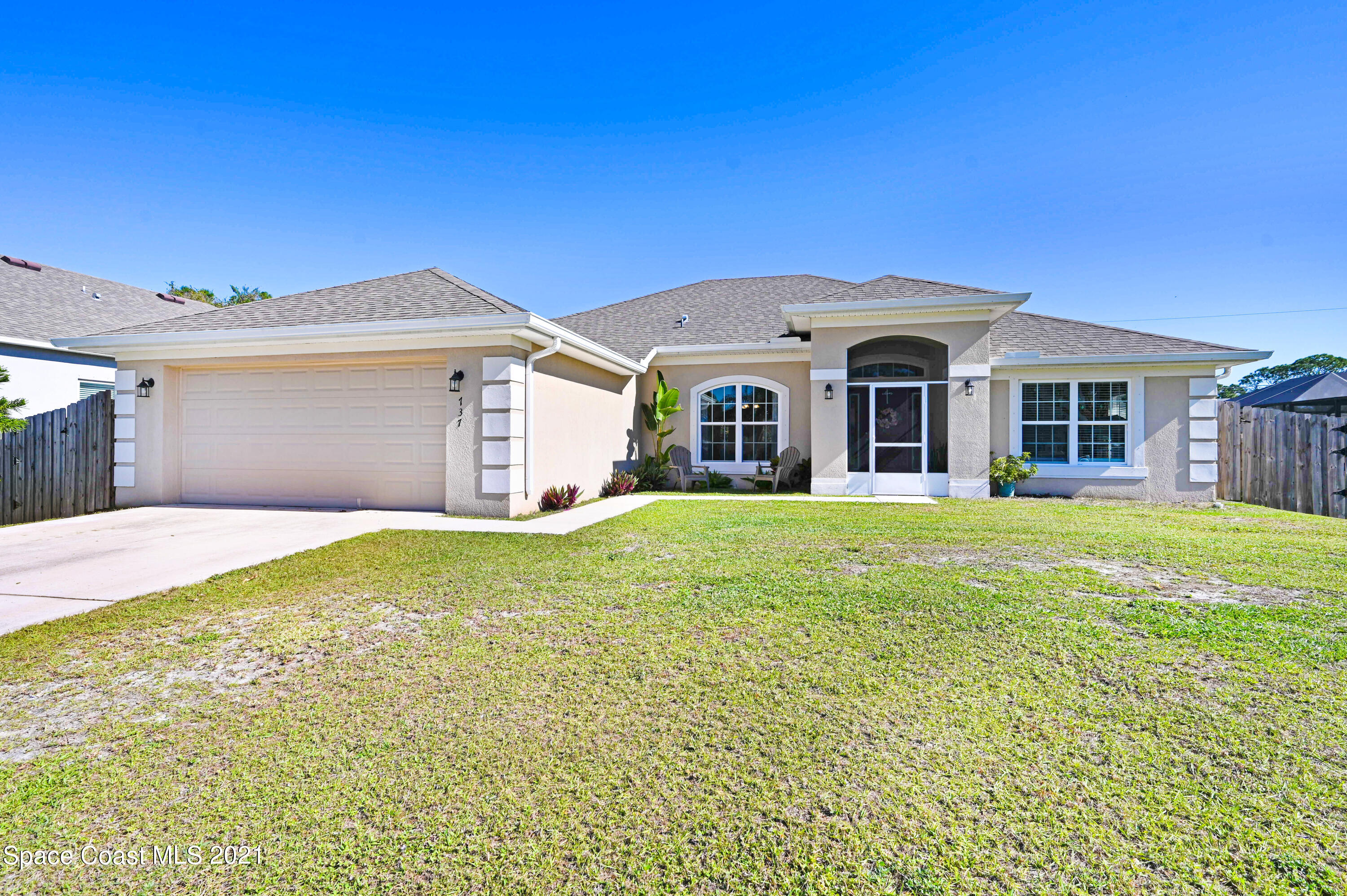 737 Atlantis Road Southeast Palm Bay, FL 32909 - Photo 1 of 29 a front view of a house with a garden