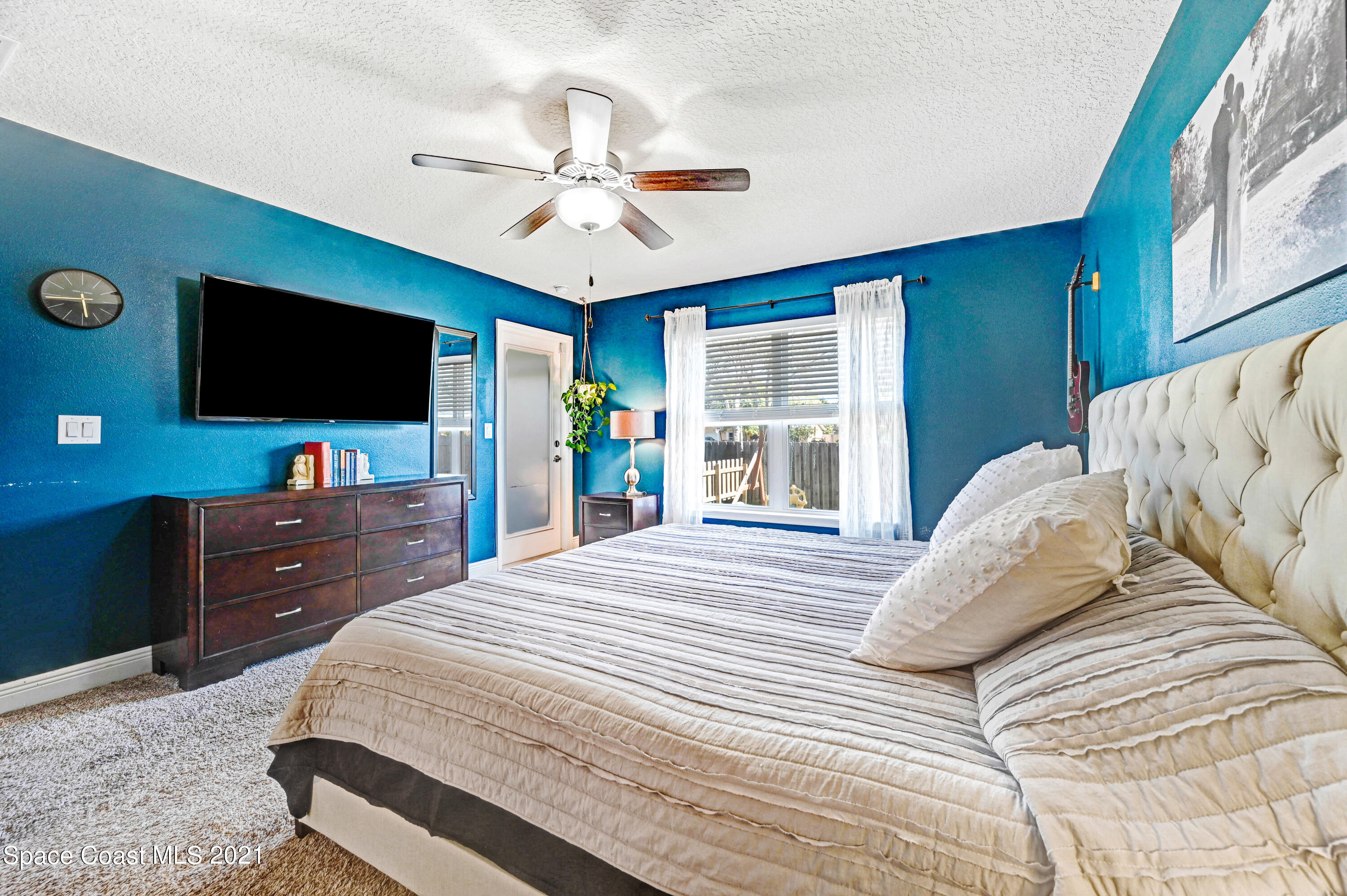 737 Atlantis Road Southeast Palm Bay, FL 32909 - Photo 13 of 29 a bedroom with a bed and a flat screen tv