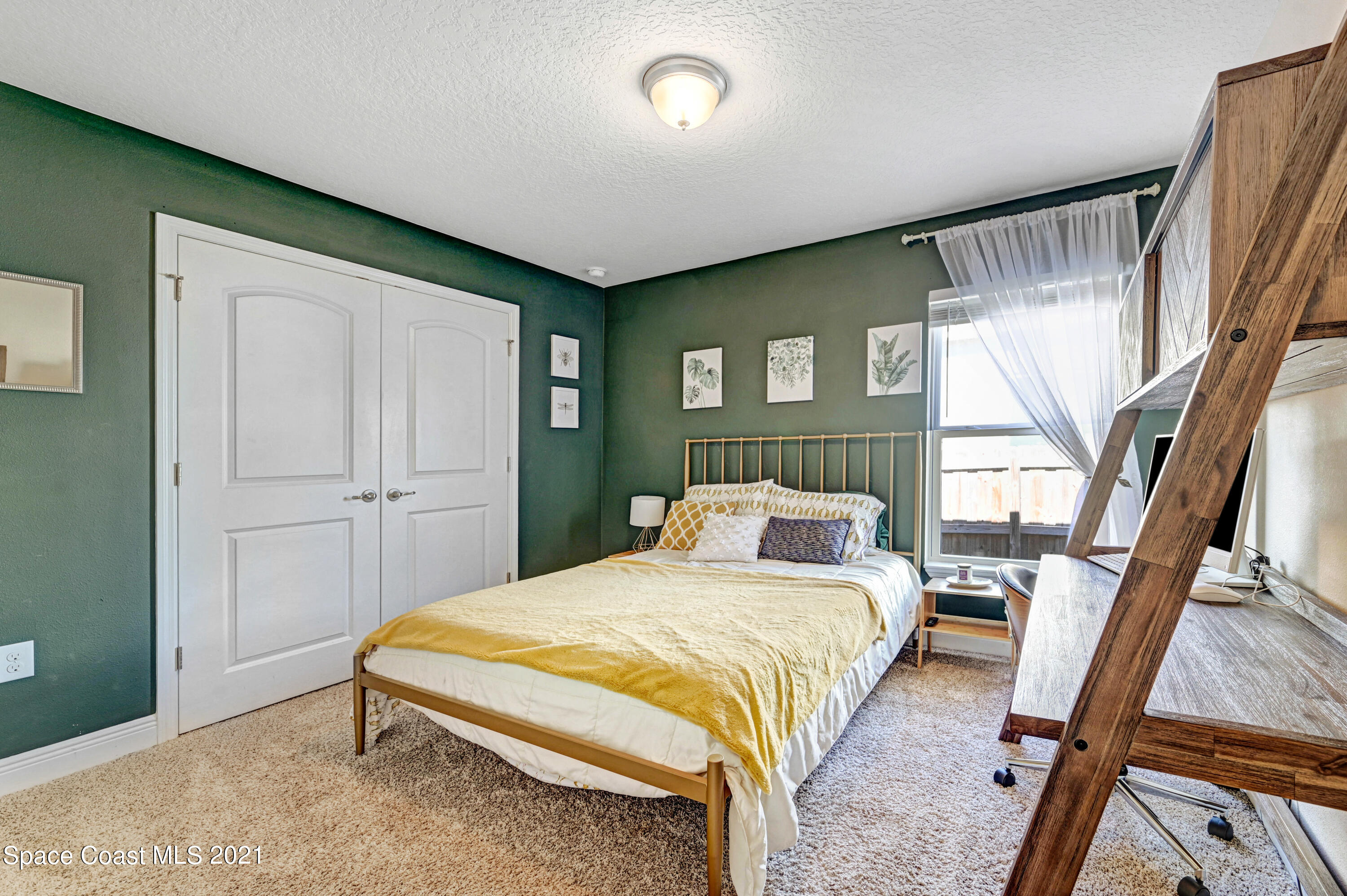 737 Atlantis Road Southeast Palm Bay, FL 32909 - Photo 17 of 29 a bedroom with a bed and a large window