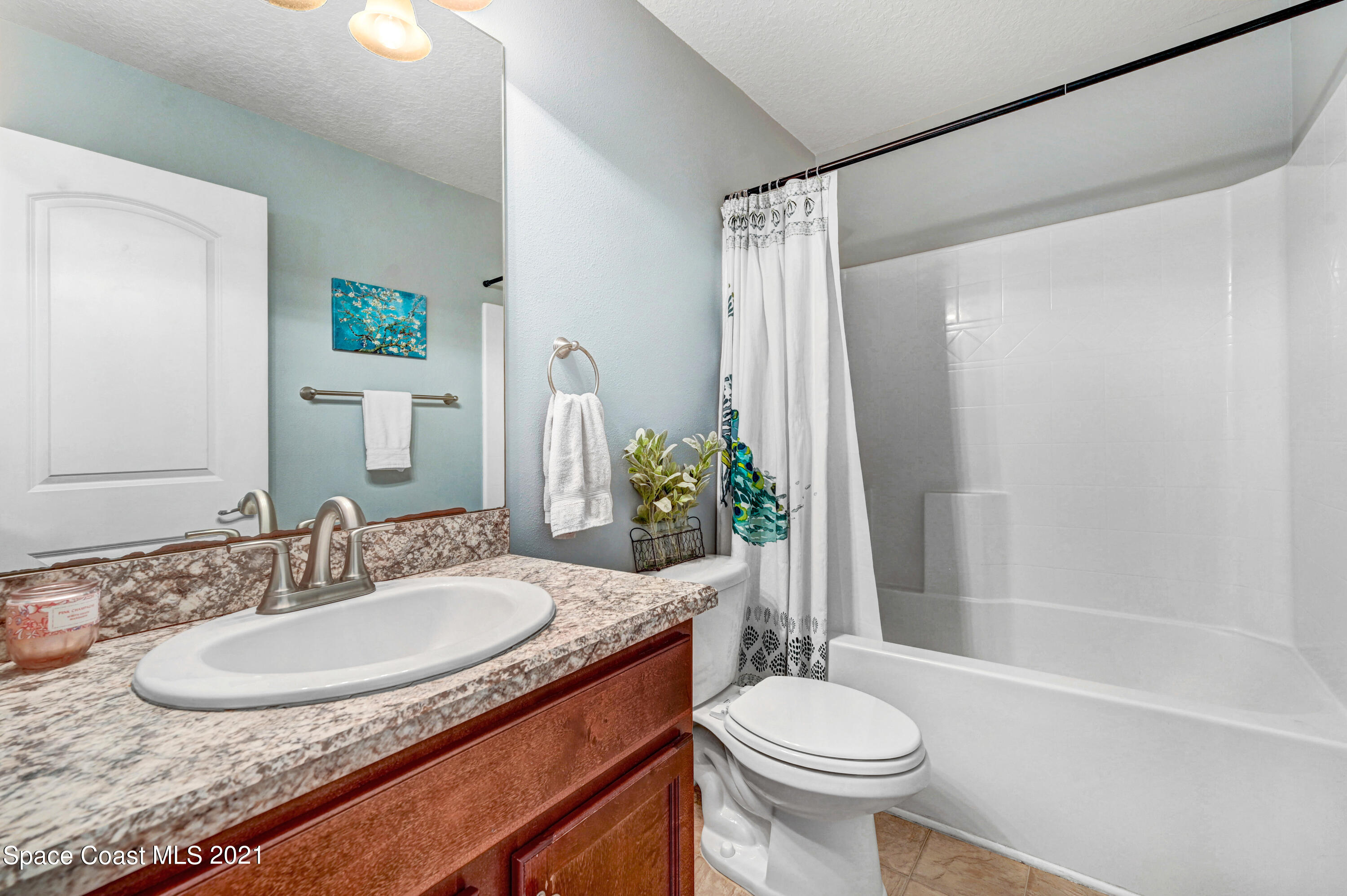 737 Atlantis Road Southeast Palm Bay, FL 32909 - Photo 18 of 29 a bathroom with a sink and a mirror