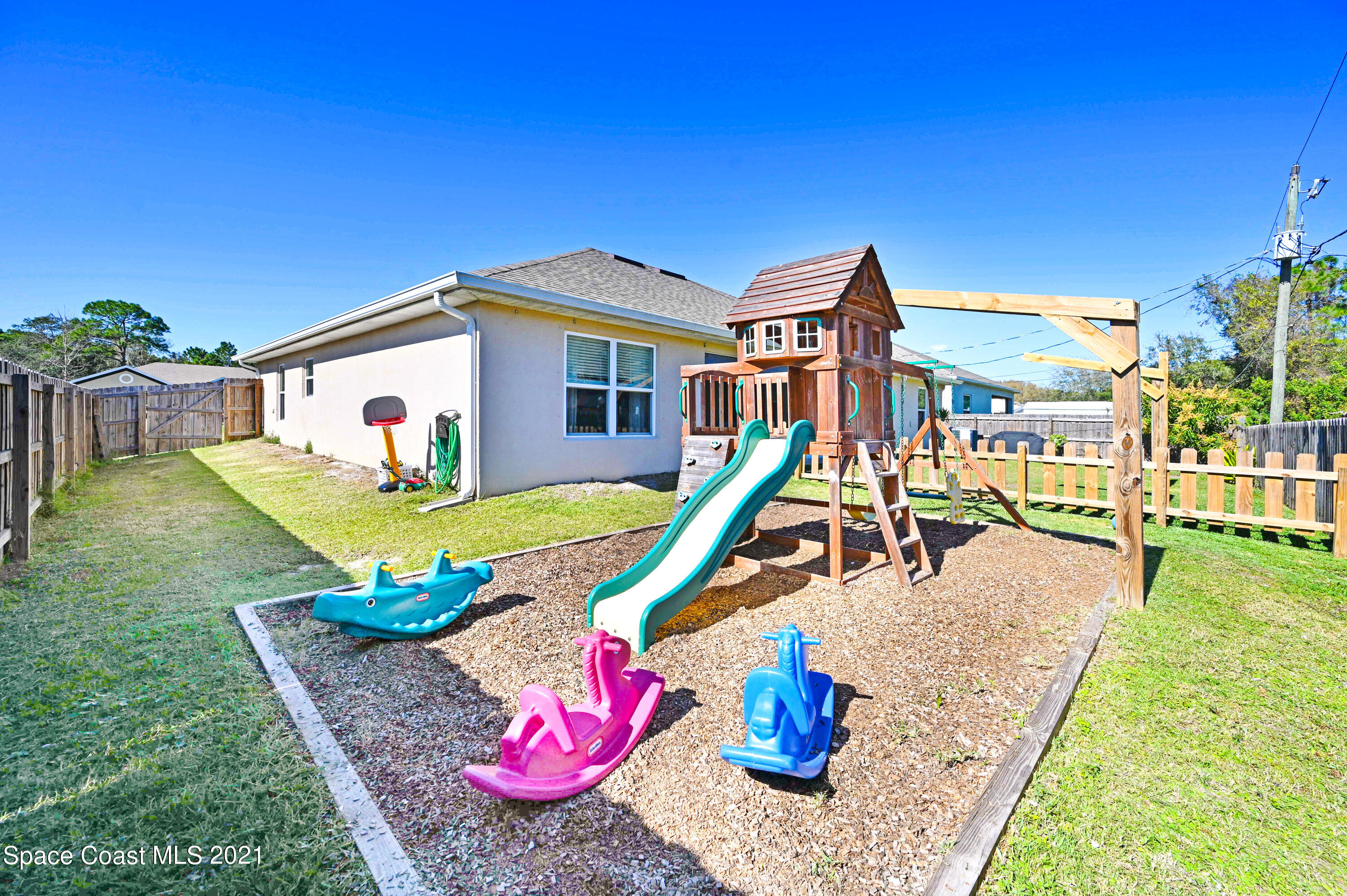 737 Atlantis Road Southeast Palm Bay, FL 32909 - Photo 25 of 29 a view of a house with backyard porch and furniture