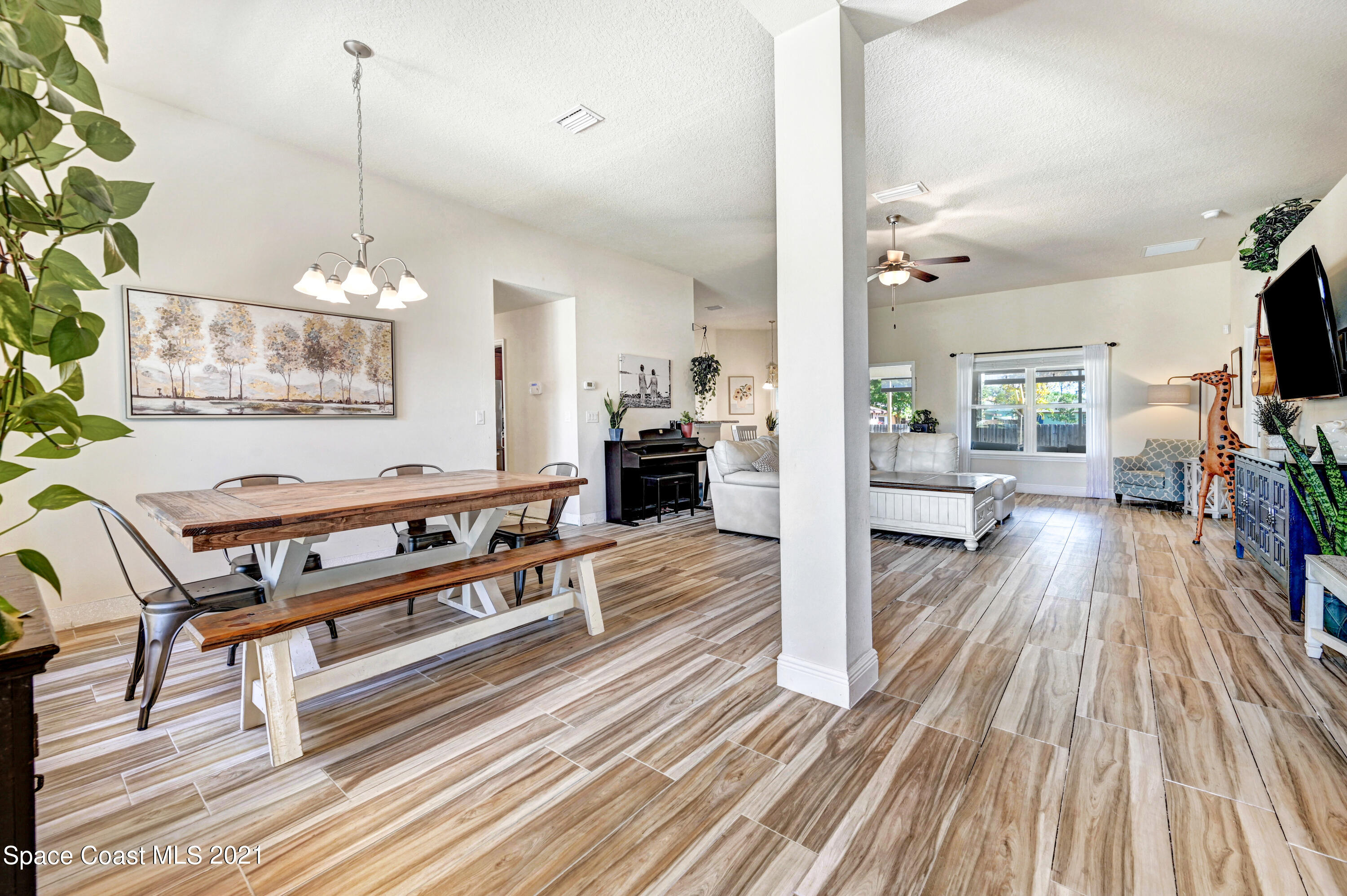 737 Atlantis Road Southeast Palm Bay, FL 32909 - Photo 3 of 29 a living room with furniture and a wooden floor