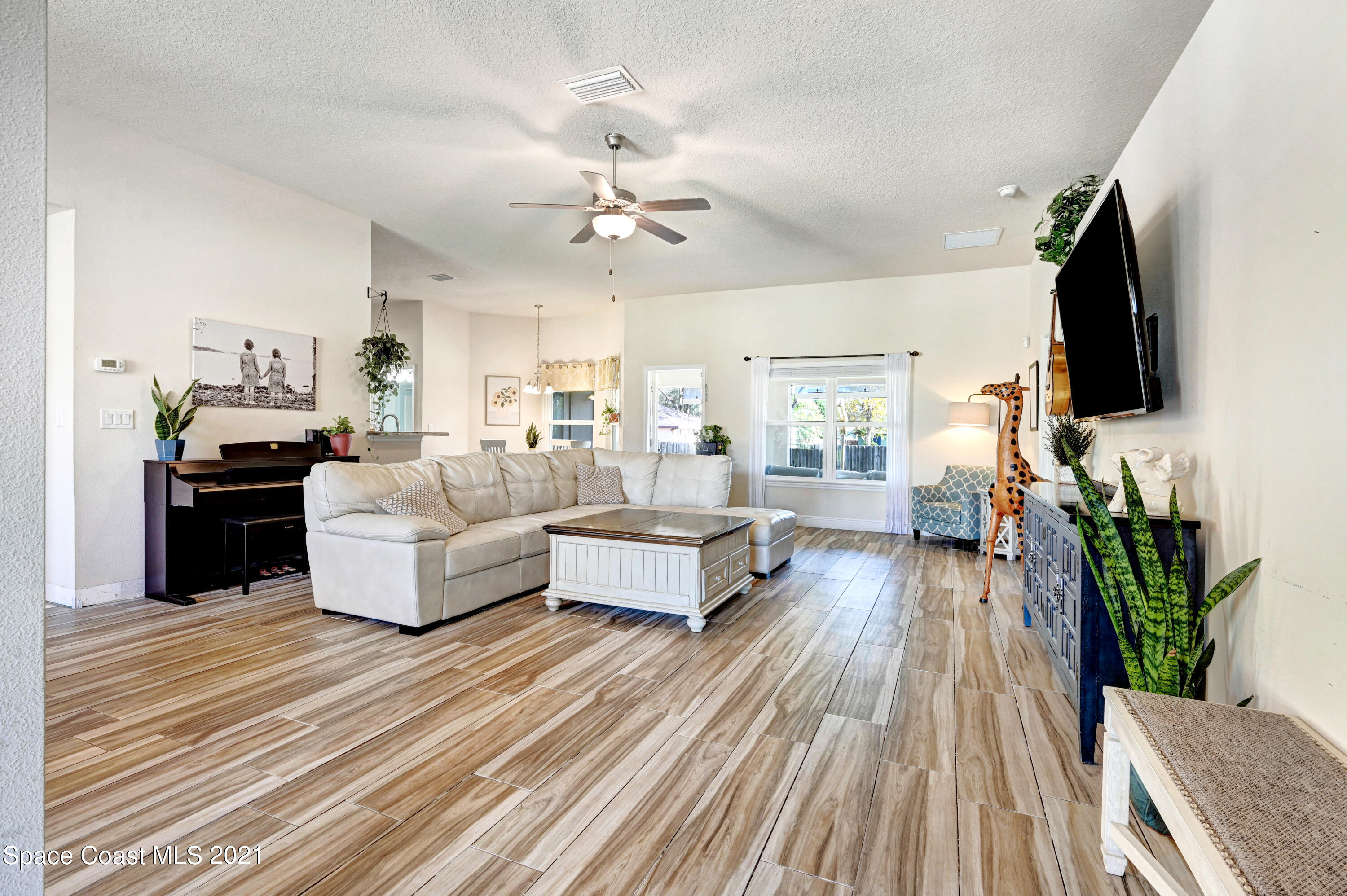 737 Atlantis Road Southeast Palm Bay, FL 32909 - Photo 4 of 29 a living room with furniture fireplace and flat screen tv