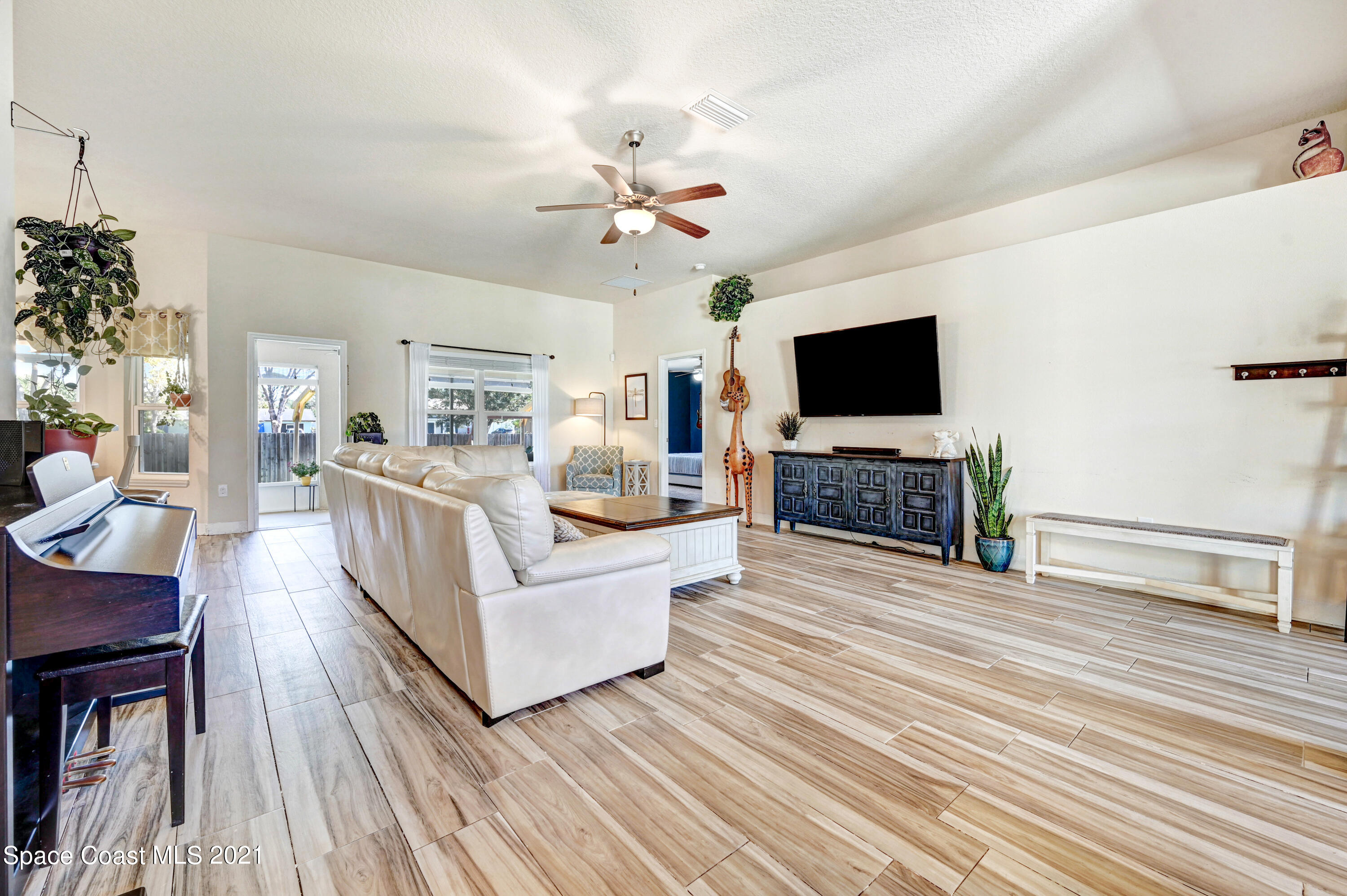 737 Atlantis Road Southeast Palm Bay, FL 32909 - Photo 9 of 29 a living room with fireplace furniture and a flat screen tv