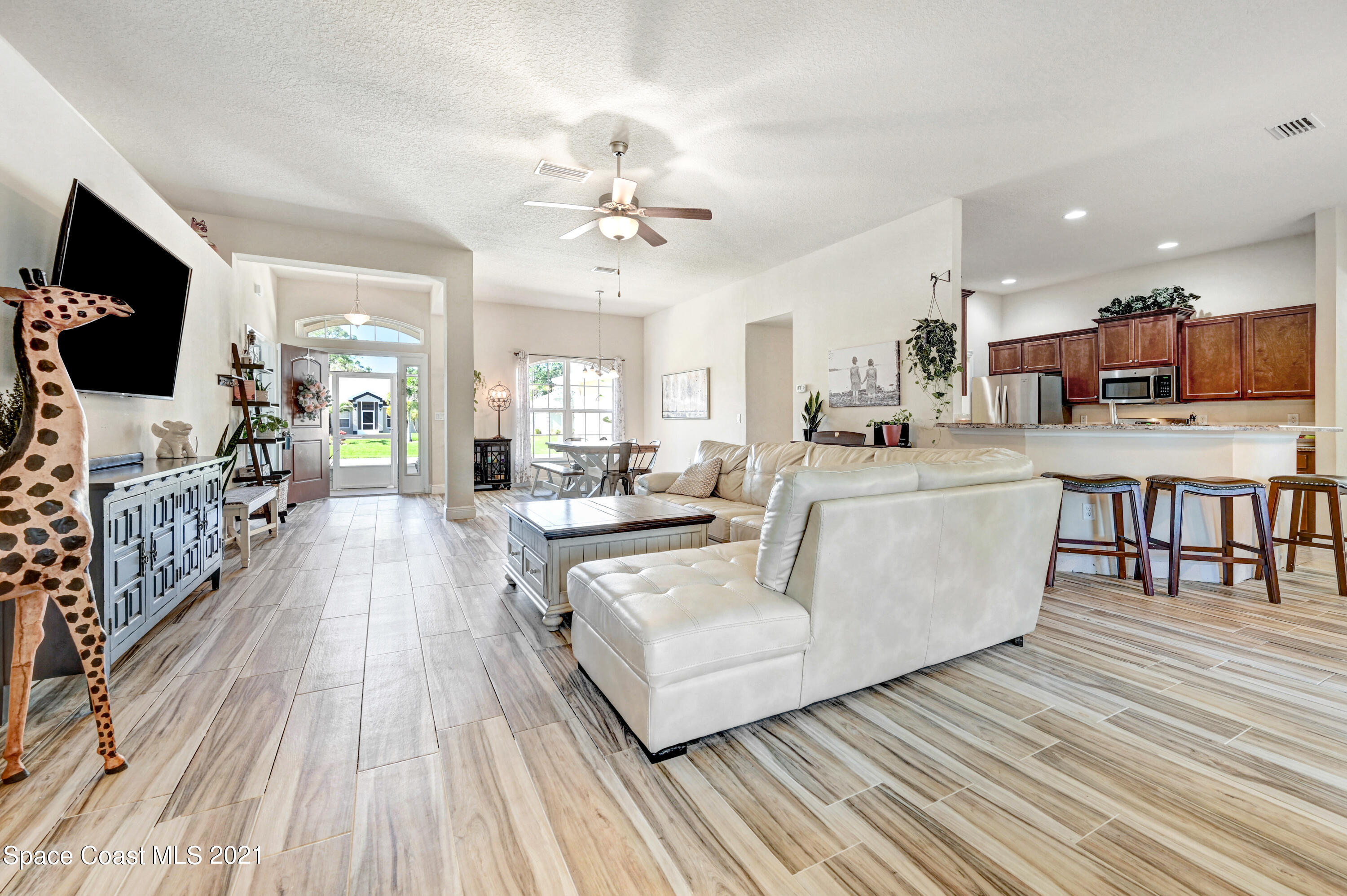 737 Atlantis Road Southeast Palm Bay, FL 32909 - Photo 10 of 29 a living room with furniture and a flat screen tv