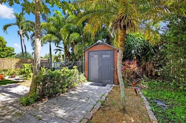 a view of swimming pool with a patio and a garden