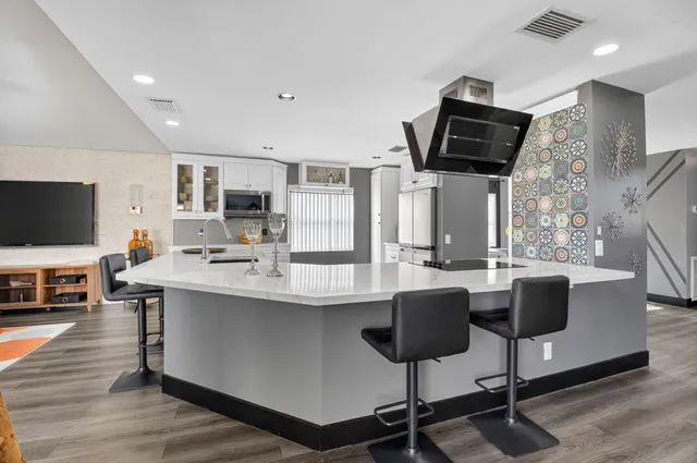 a kitchen with stainless steel appliances granite countertop a stove and a sink