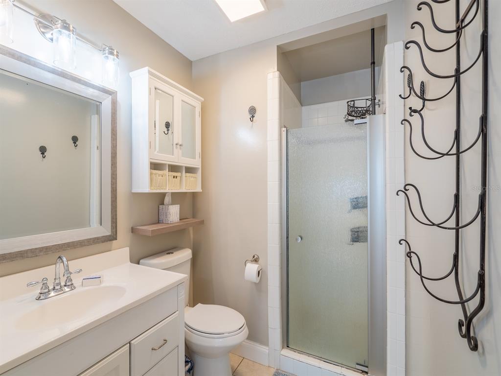 13425 Maple Drive Fort McCoy, FL 32134 - Photo 15 of 41 a bathroom with a granite countertop sink toilet and shower