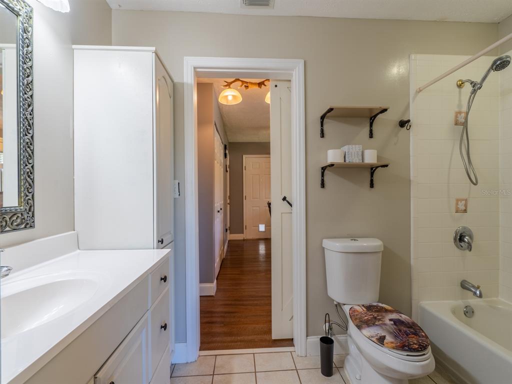 13425 Maple Drive Fort McCoy, FL 32134 - Photo 19 of 41 a bathroom with a sink a toilet and shower