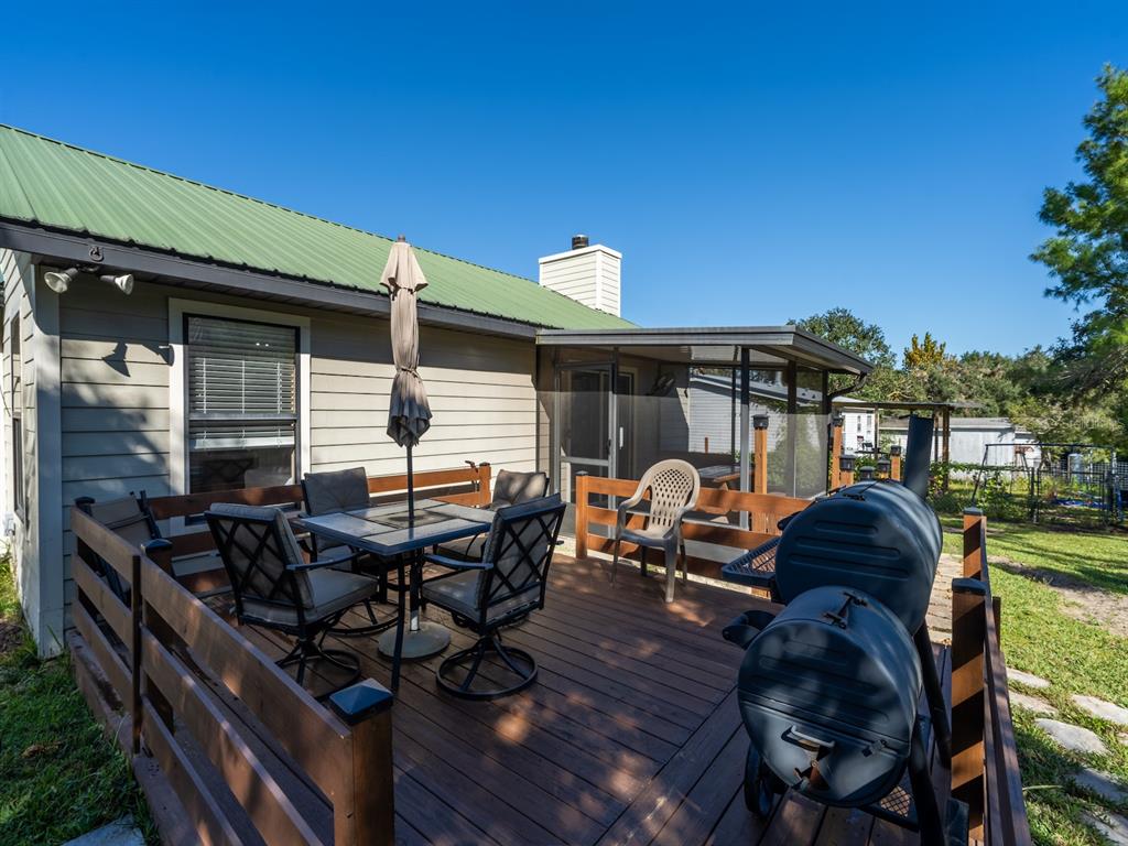 13425 Maple Drive Fort McCoy, FL 32134 - Photo 24 of 41 a roof deck with table and chairs and potted plants