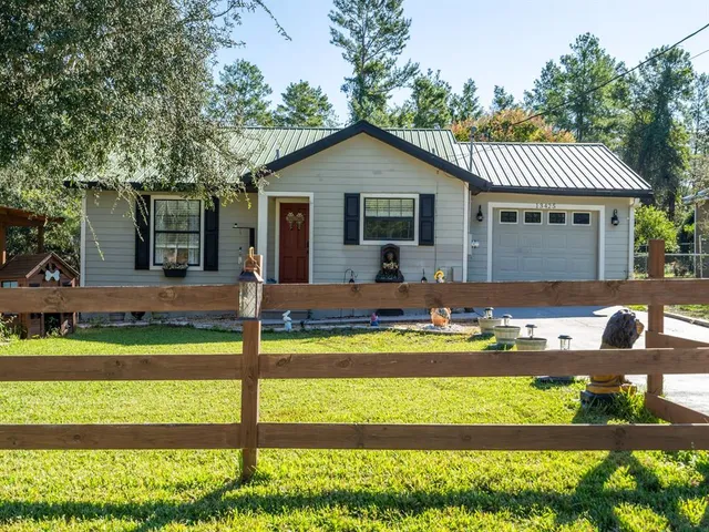 a front view of house with a garden and patio