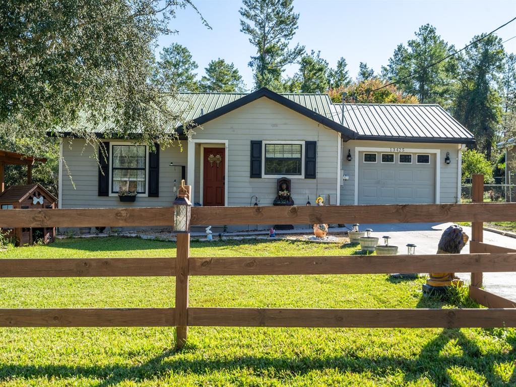 13425 Maple Drive Fort McCoy, FL 32134 - Photo 28 of 41 a front view of house with a garden and patio