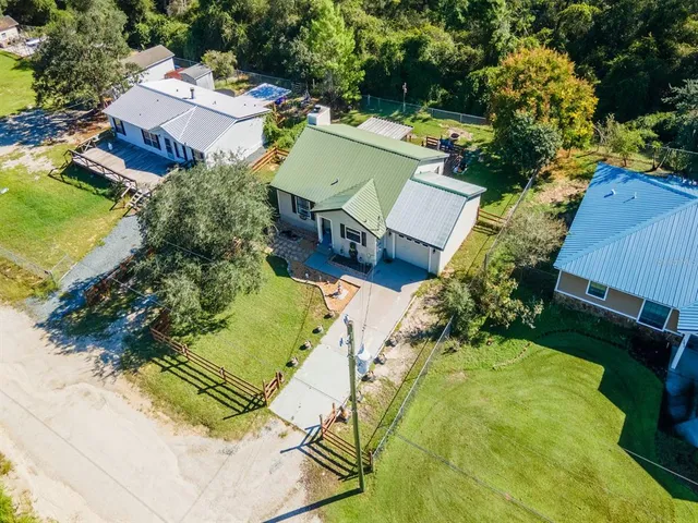 an aerial view of a house with a garden and swimming pool
