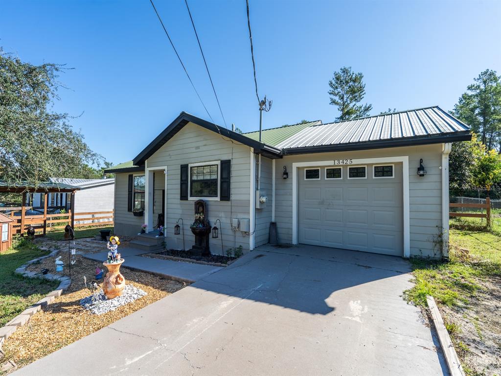 13425 Maple Drive Fort McCoy, FL 32134 - Photo 5 of 41 a front view of a house with garden