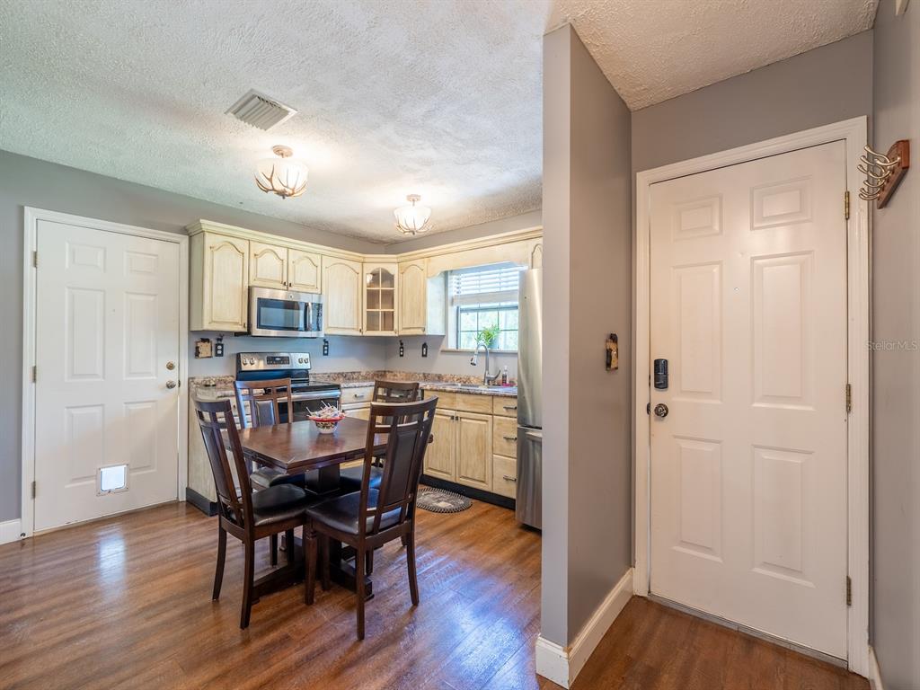 13425 Maple Drive Fort McCoy, FL 32134 - Photo 6 of 41 a view of a dining room with furniture and wooden floor