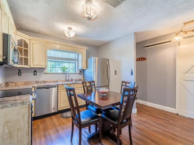 a view of a dining room with furniture and wooden floor