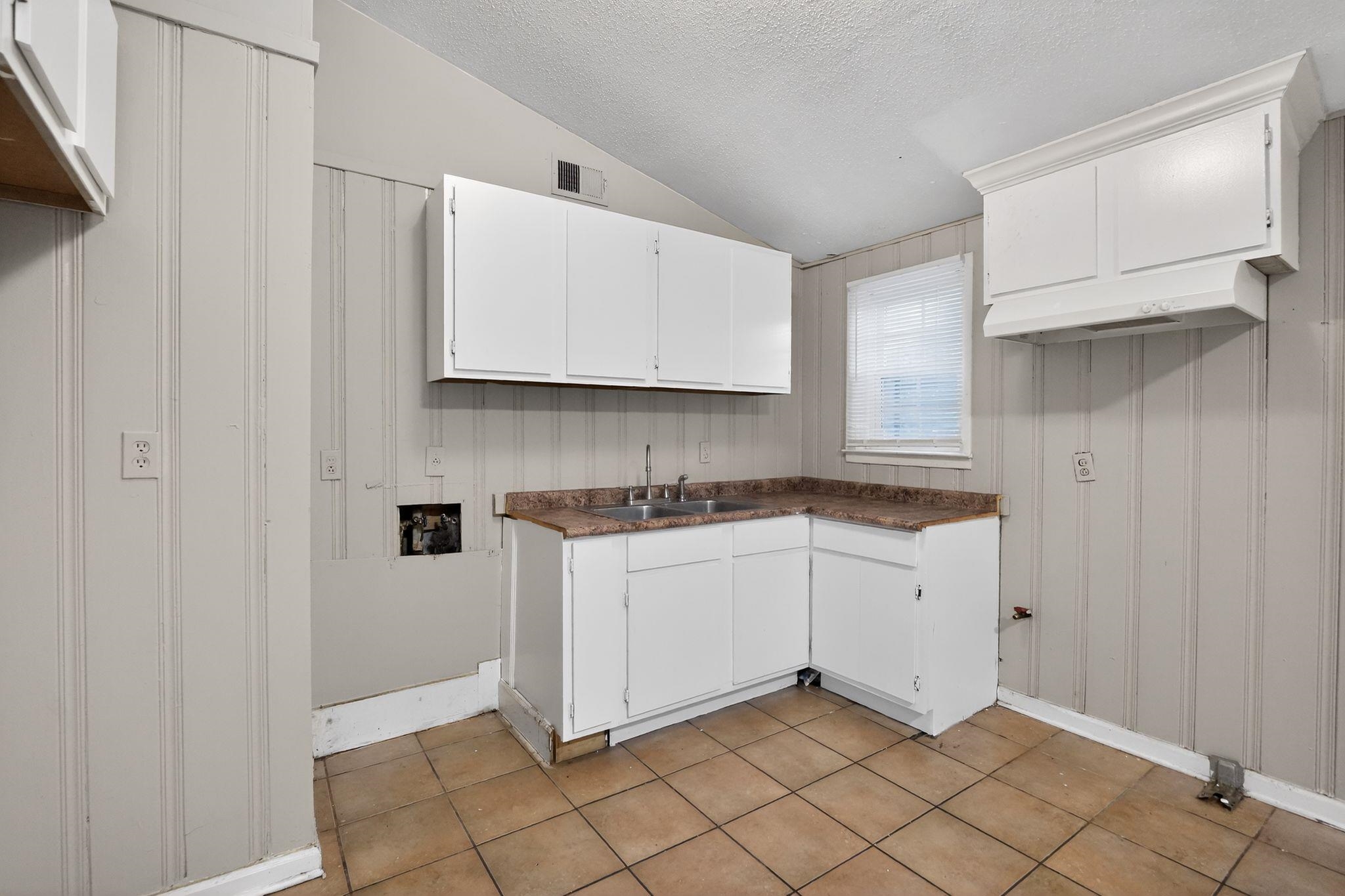 4504 Neely Road Memphis, TN 38109 - Photo 19 of 32 a kitchen with granite countertop white cabinets and sink