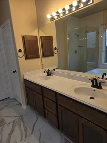 a bathroom with a double vanity sink and mirror