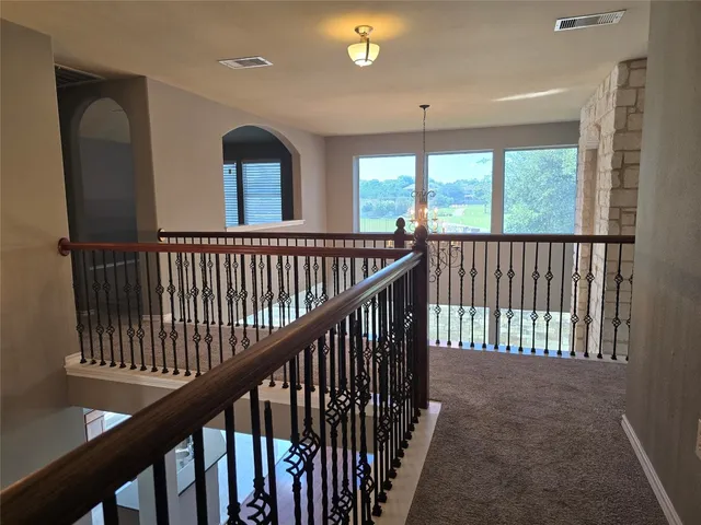 a view of staircase with wooden floor and fan