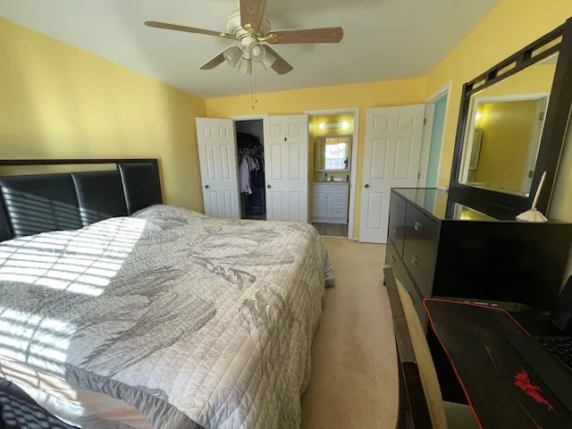 a spacious bedroom with a bed and a mirror