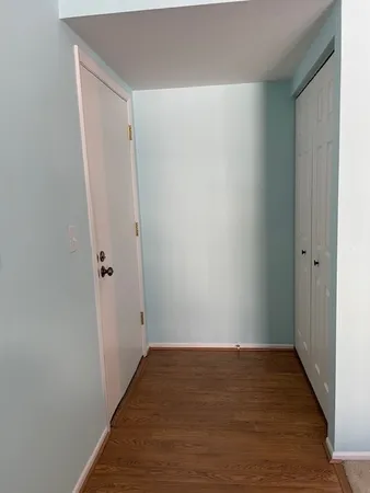 a view of an empty room with wooden floor