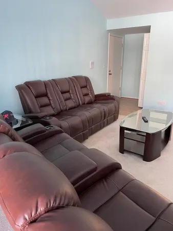 a living room with furniture and a mirror