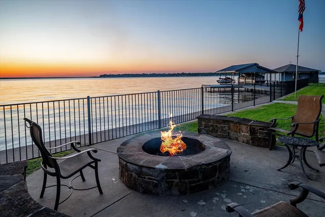 a view of a swimming pool with a patio and a fire pit