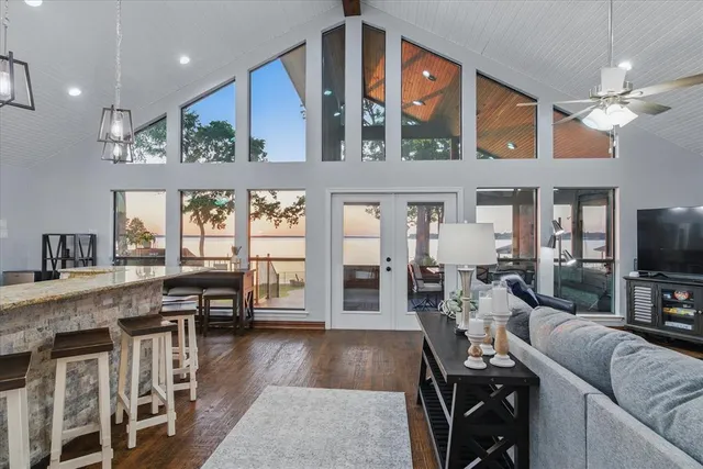 a living room with furniture a chandelier and a flat screen tv