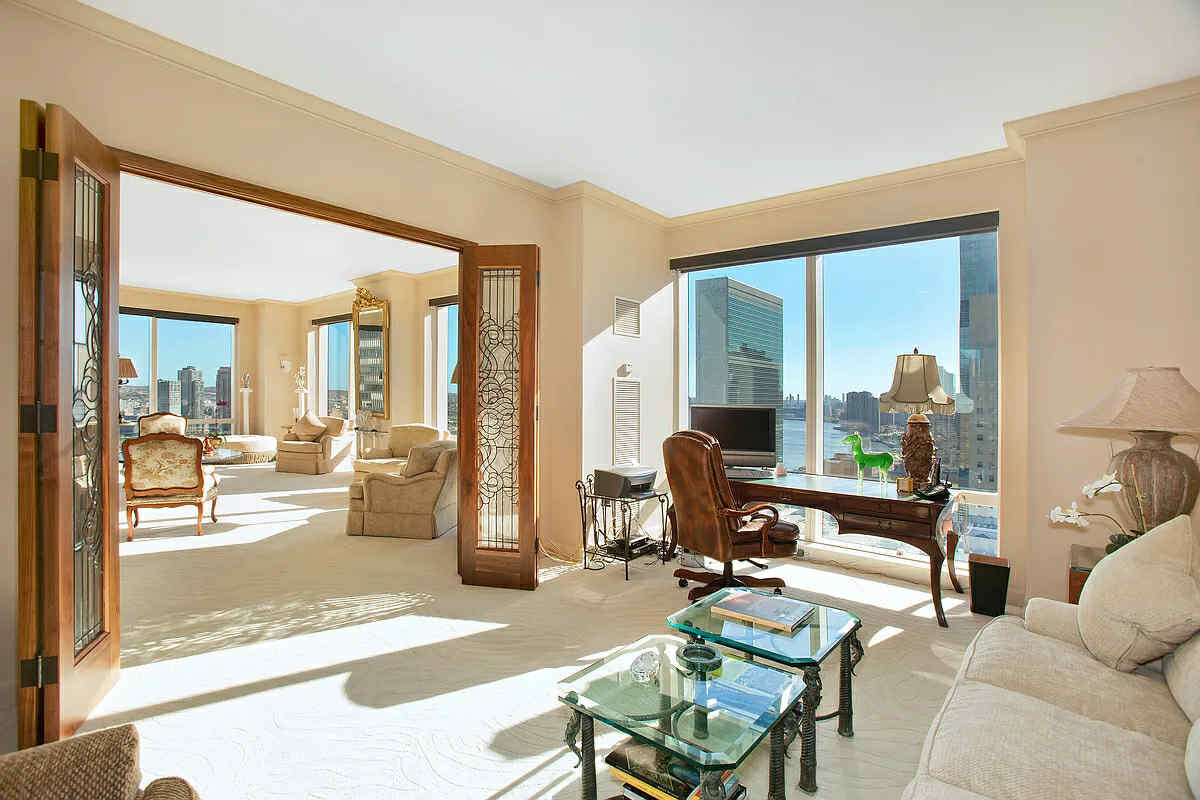 845 United Nations Plaza, Unit 32B Manhattan, NY 10017 - Photo 2 of 9 a living room with furniture and a table