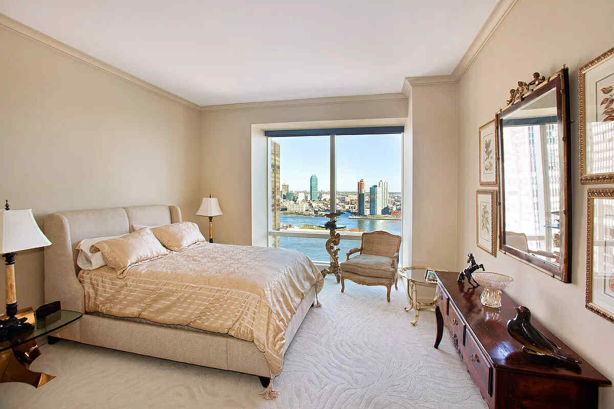 845 United Nations Plaza, Unit 32B Manhattan, NY 10017 - Photo 3 of 9 a bedroom with a bed and a large window with outer view