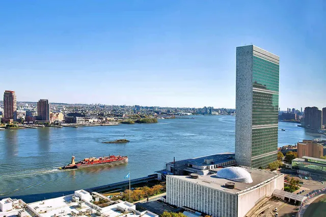 a bedroom with a bed a large window and walk in closet