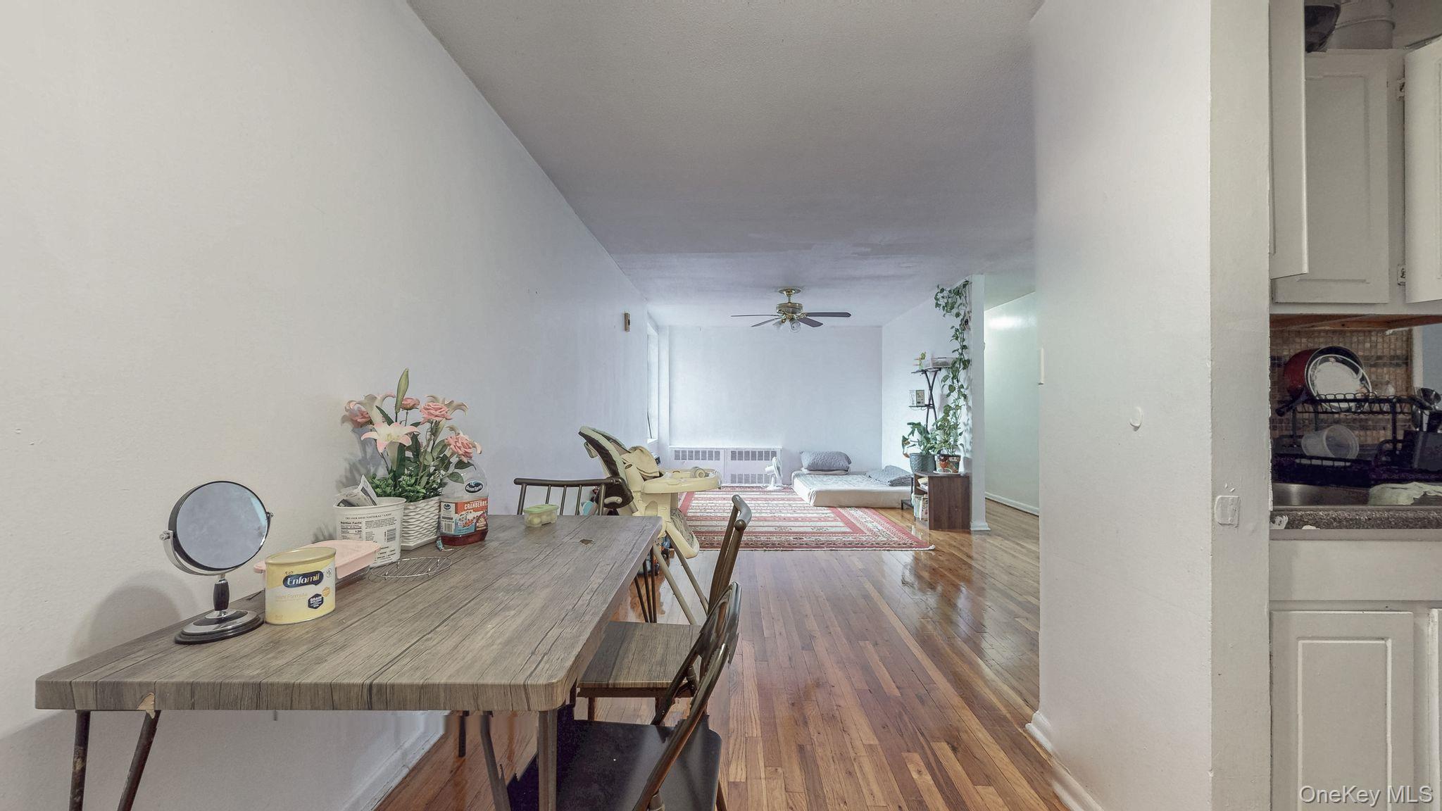 41-42 73rd Street, Unit 7J Queens, NY 11377 - Photo 4 of 8 a view of a dining room with furniture and wooden floor