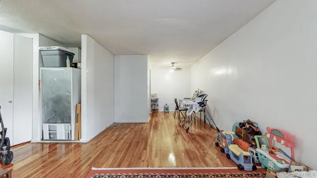 a view of a room with wooden floor