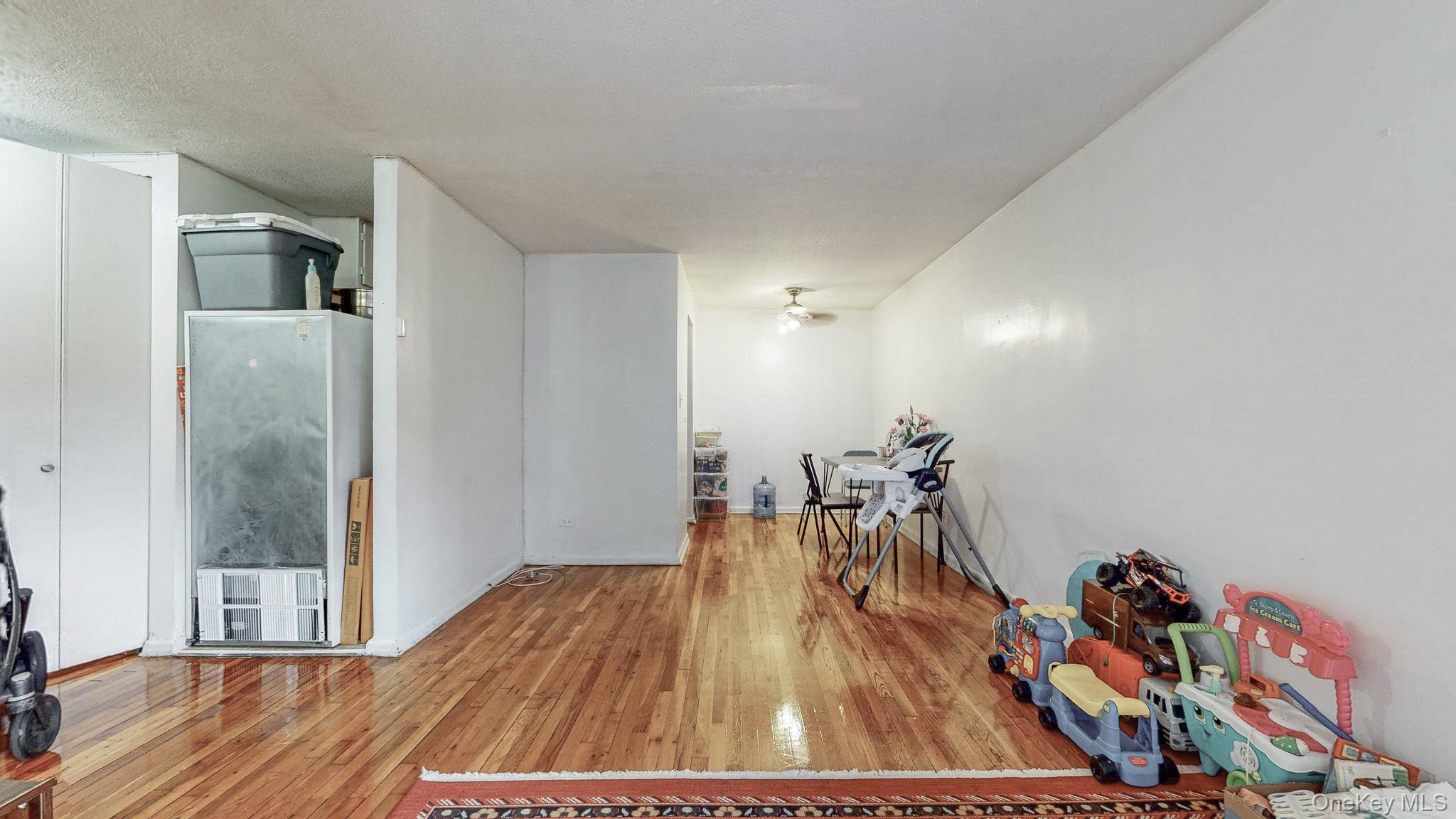 41-42 73rd Street, Unit 7J Queens, NY 11377 - Photo 5 of 8 a view of a room with wooden floor