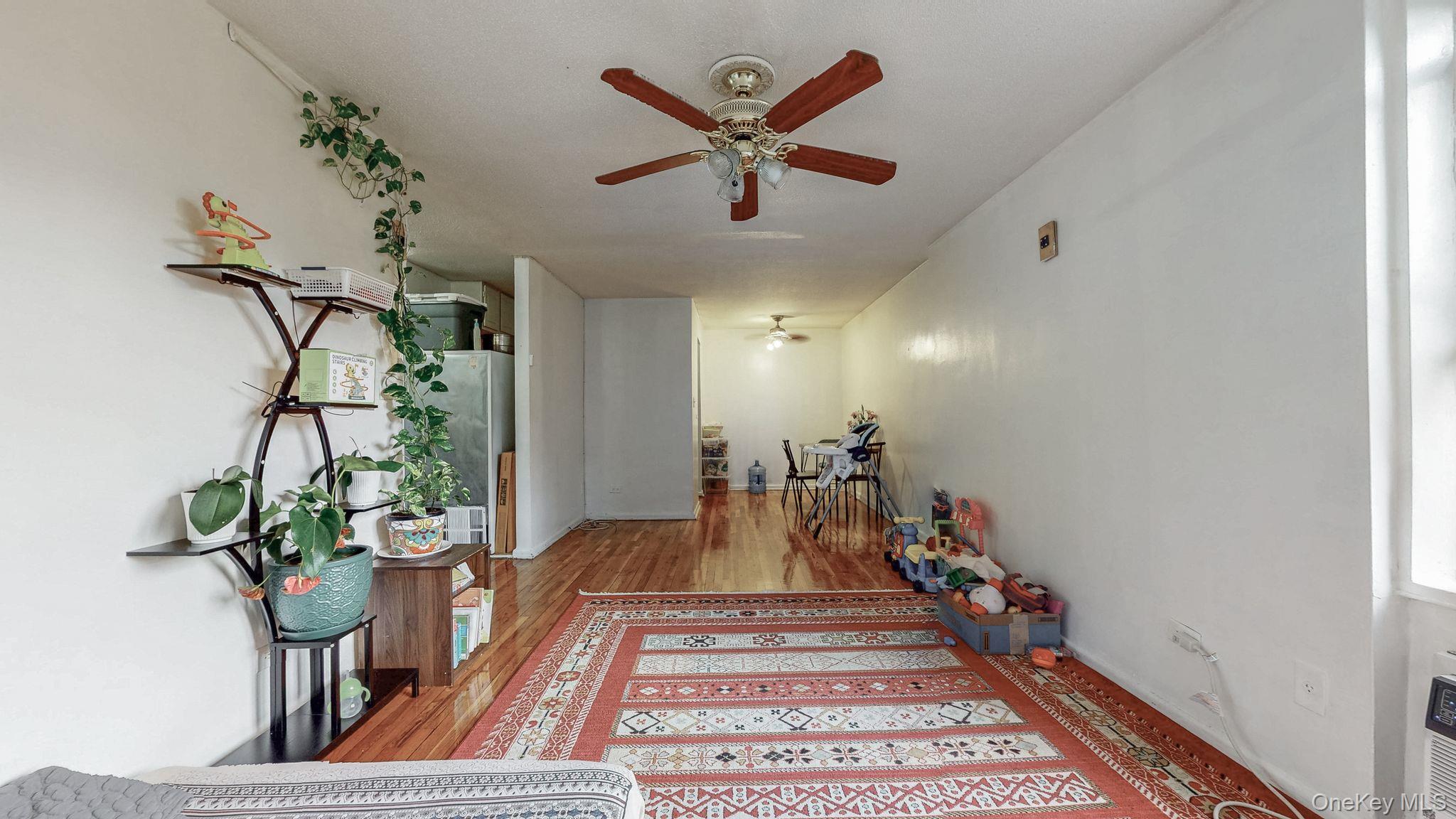 41-42 73rd Street, Unit 7J Queens, NY 11377 - Photo 6 of 8 a view of a hallway with a potted plant
